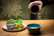 Heather Miller pours ginger syrup in tofu at  Claws of Mantis, a pop-up restaurant located in Japantown in San Francisco, Calif.