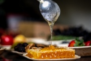 Dina Bshara drizzles honey on a honey comb while she creates a charcuterie grazing board in a kitchen at Bursa Restaurant in San Francisco, Calif. on Thursday, January 28, 2020.